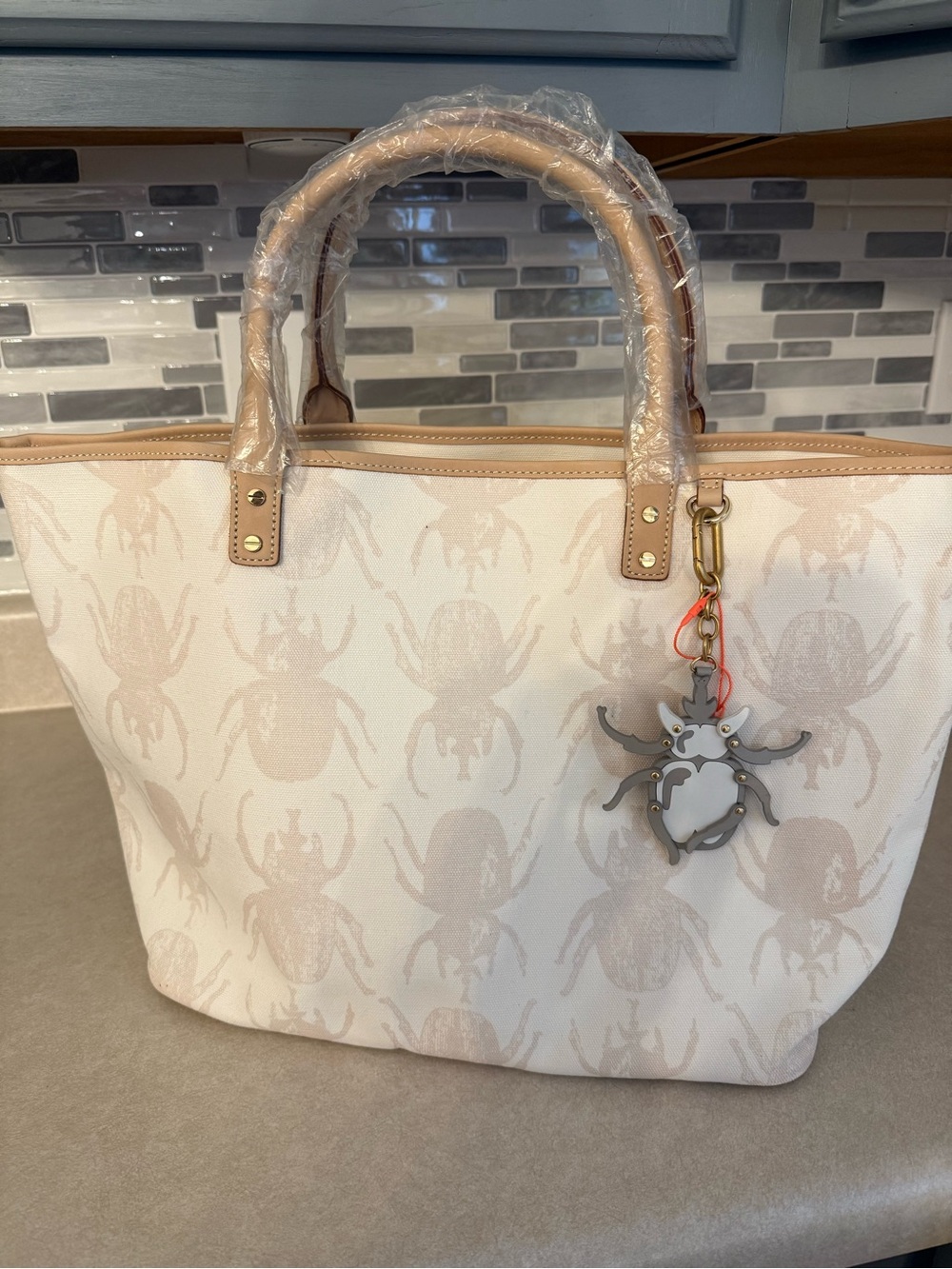 India Hicks Cream Canvas Tote with Tan Trim and Beetle Charm Accent